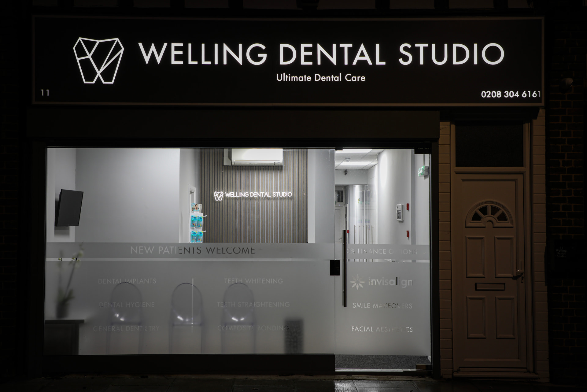 Welling Dental Studio shopfront on Falconwood Parade at night