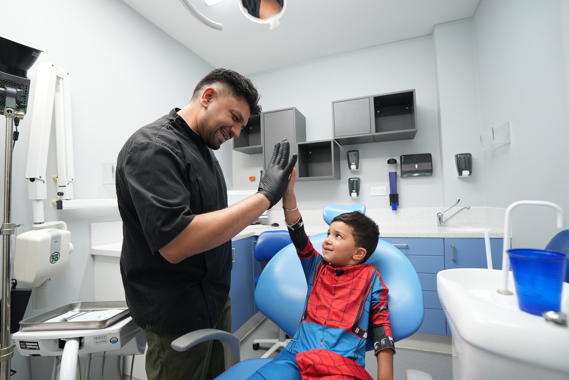 Dentist reassuring a young patient